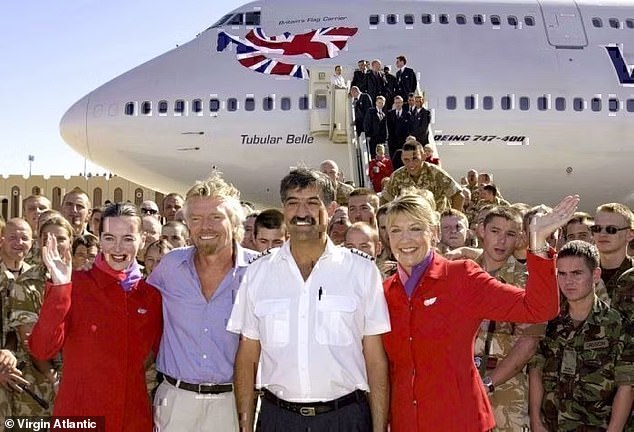 In 2003, Virgin Atlantic delivered 60 tonnes of aid to Iraq using a Boeing 747. Sir Richard is pictured above with the plane at Basra Airport.