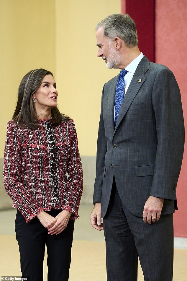 The couple chatted at the Royal Palace in Madrid while meeting officials from the charity.