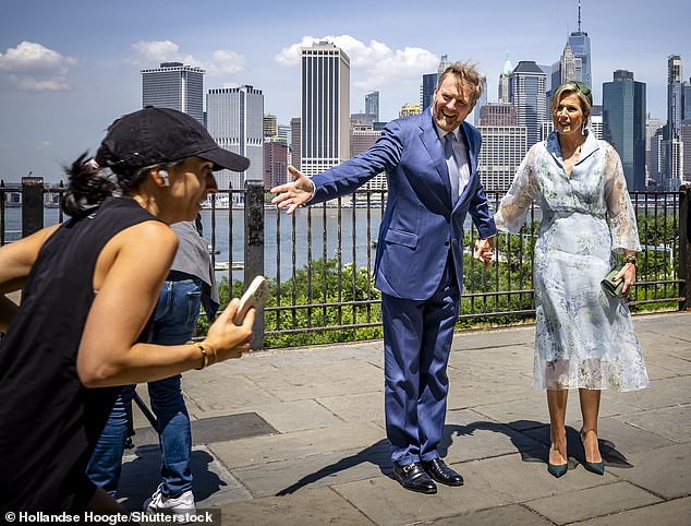 Willem-Alexander and Maxima dodged joggers along the boardwalk for a quick photo by the river.