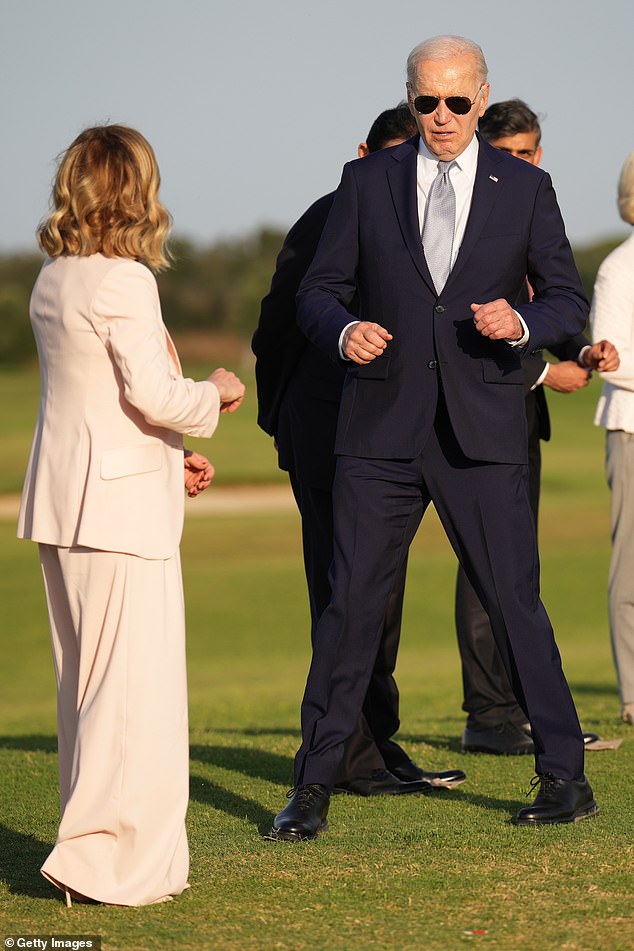 US President Joe Biden joins G7 leaders as they gather to watch a parachute drop at the San Domenico Golf Club during the first day of the 50th G7 summit on June 13, 2024.