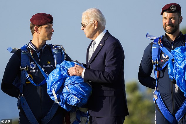 U.S. President Joe Biden greets an Italian army paratrooper after watching a skydiving demonstration during the G7 world leaders summit in Borgo Egnazia, Italy, Thursday, June 13, 2024.