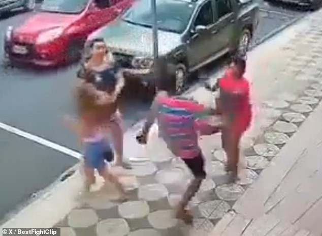 A man (bottom right) responds forcefully after seeing a woman (top right) hit a young woman (bottom left) for no reason on a street in Brazil.