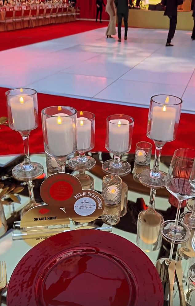 The glamorous event featured lots of candles and plenty of red accents on the tables.