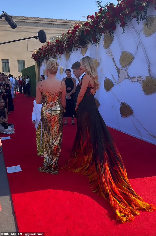 She walked the red carpet with her dad Clark and her mom Tavia, who surprised in a gold dress.