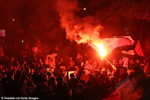 People with Iranian flags gather to hold a rally in support of Iran's attack on Israel in Tehran, Iran, on April 14.