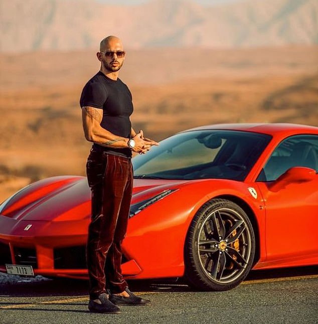 Tate is seen doing the hand gesture again while posing in front of a luxurious red Ferrari.