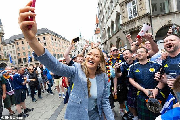 The ITV presenter could be seen laughing as she posed for some photos with the eccentric fans (pictured above).