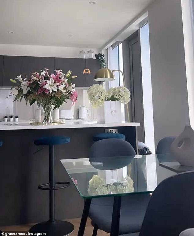 Inside, the kitchen has a sleek look, complete with a breakfast bar with swivel stools and sleek herringbone wood floors.