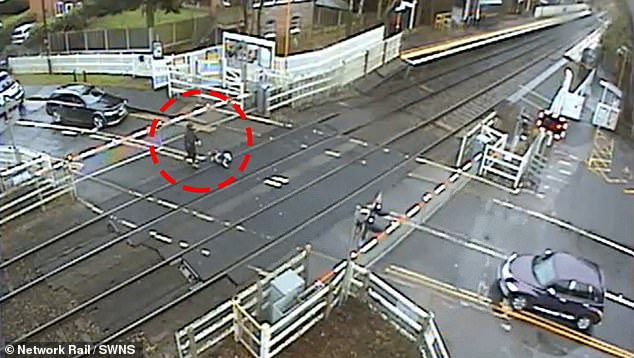 Heart-stopping footage shows the man ignoring flashing red lights and crashing through barriers at Blakedown station in Worcestershire.