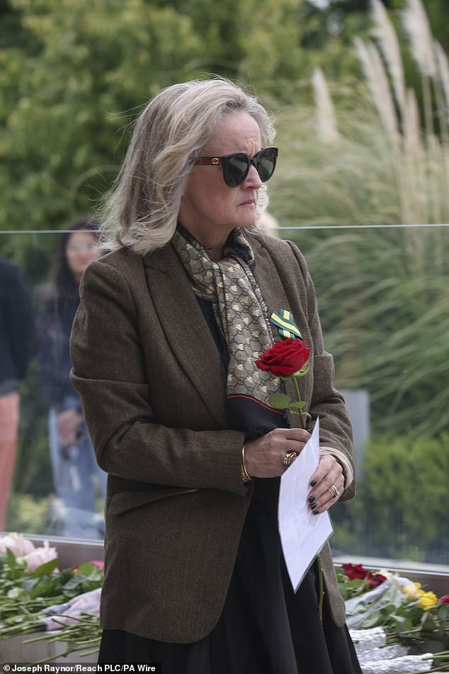 The families of the three victims of the Nottingham attack gathered to remember the trio (pictured: Dr Sinead O'Malley, mother of Grace O'Malley Kumar, placed a single rose on the pavement in memory of her daughter) .