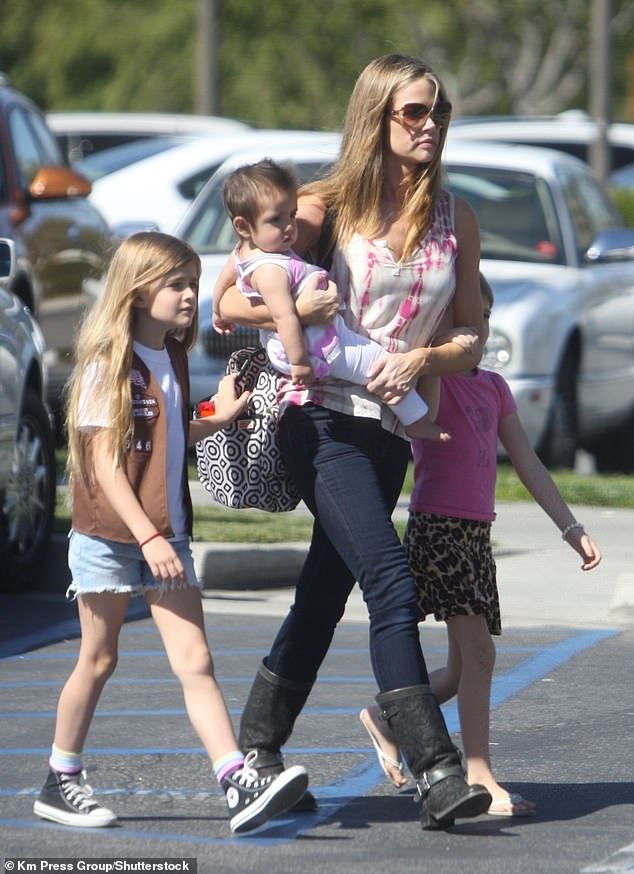 Lola Sheen, along with her sister Sami, 20, and mother Denise Richards, 53, have signed on to star in the upcoming reality show currently titled Denise Richards and the Wild Things (pictured in Los Angeles in March 2012 with Richards holding his younger sister Eloise).