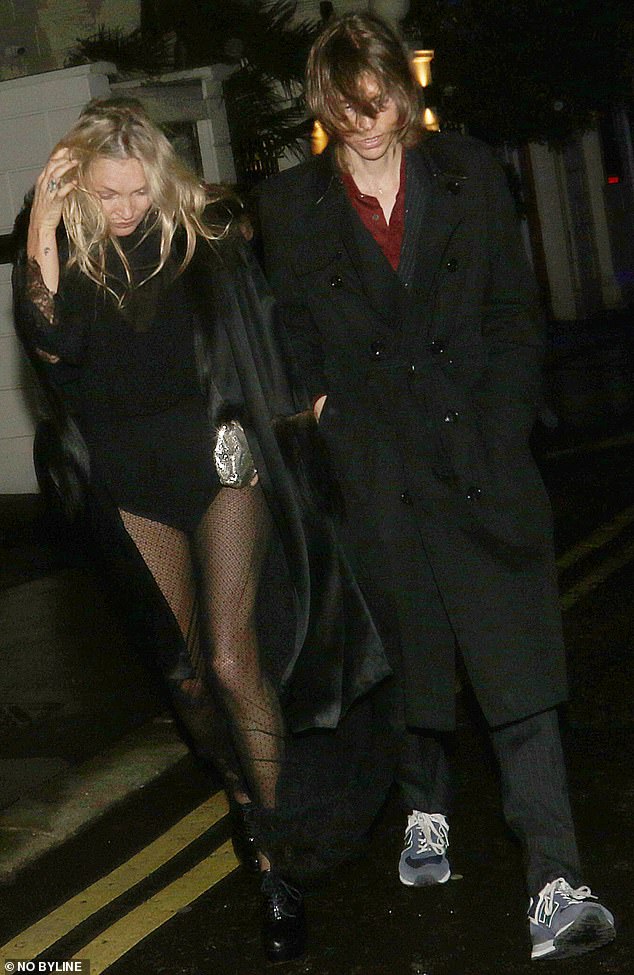 The supermodel is photographed with a mystery man while leaving Cabaret at the Kit Kat club in May