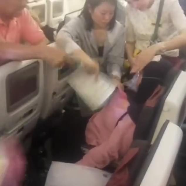 The woman was surrounded by fellow travelers who tried to help her calm down.