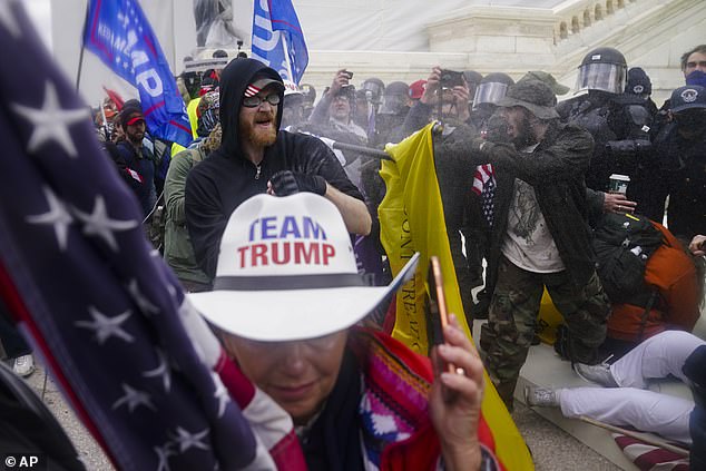 Insurrectionists loyal to President Donald Trump try to break through a police barrier at the Capitol in Washington on January 6, 2021.