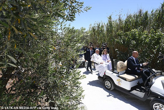 Meloni walks with the cape in a golf cart to the event site.