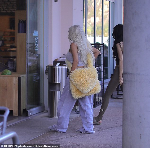 The reality show favorite made sure to turn heads with her fluffy yellow maxi shoulder bag.