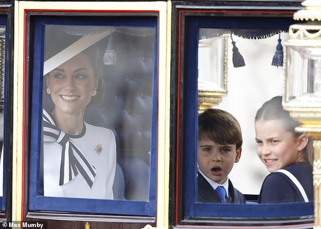 Kate smiles as she accompanies her children in a carriage during today's procession (pictured left to right: Kate, Prince Louis, Princess Charlotte)