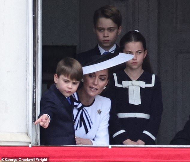 The Princess of Wales talks to Prince Louis as they watch Trooping the Color today