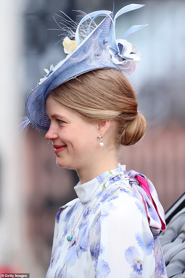 Lady Louise looked in high spirits as she traveled in a carriage with her parents yesterday.