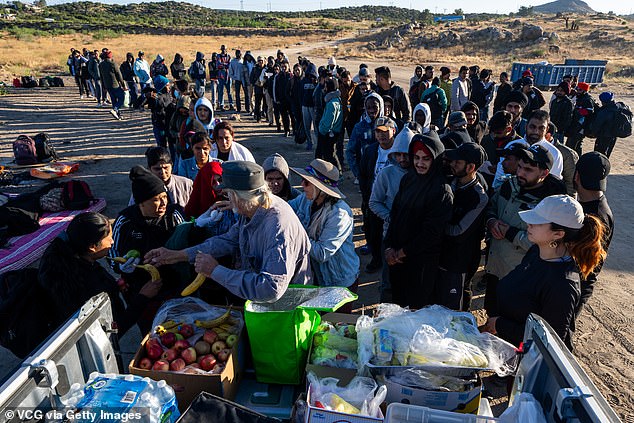 Volunteers distribute food to migrants who crossed into the United States from Mexico in Jacumba Hot Springs, California.