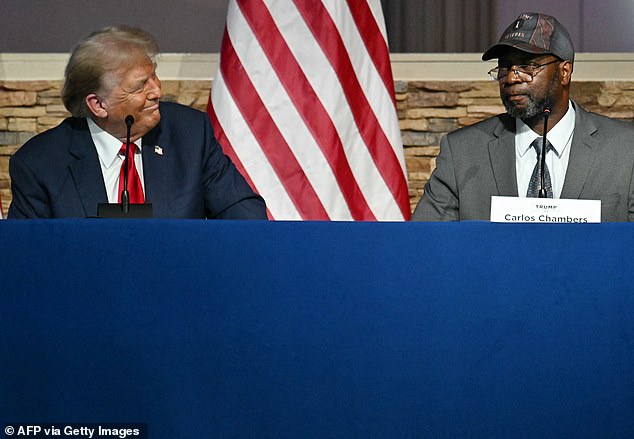 The visit ended with a prayer for Trump and a rendition of 'Happy Birthday' for the former president who turned 78 a day earlier. He is seen here sitting next to veteran Carlos Chambers.