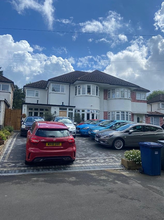 The paved front garden has been converted into a second-hand car park.