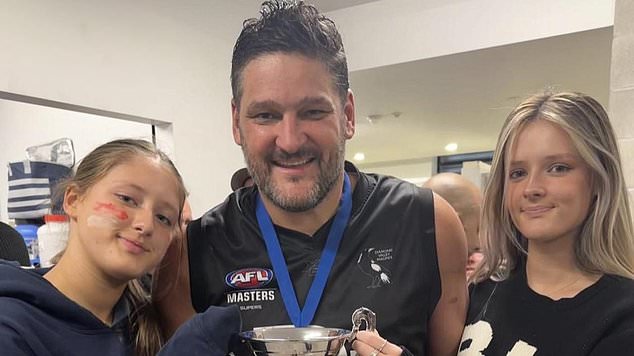 Fevola smiles with the trophy with her daughters Leni and Lulu after winning a grand final in 2023