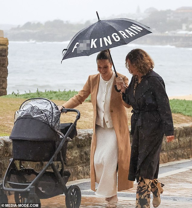 At one point, Simone's mother, Margaret, was seen covering Simone and her baby with the umbrella.