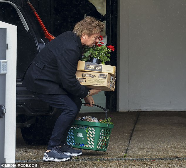 The 69-year-old TV star was photographed unloading her purchases on Saturday, including a box of potted flowers and other items, from her car.