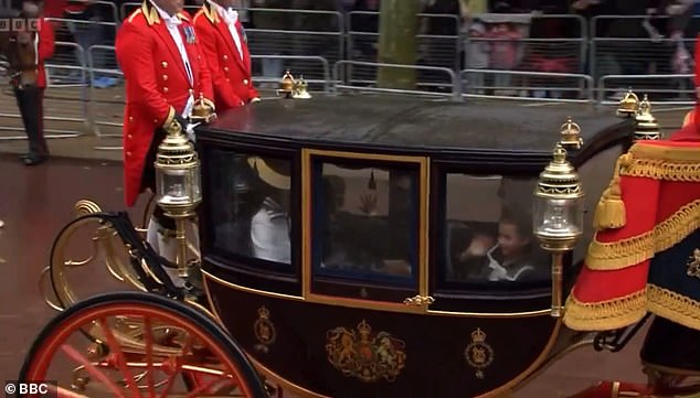 After Princess Charlotte wiped away the condensation, she looked cheerful as she waved to the crowd.