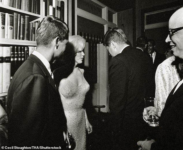 The only known photograph of Marilyn with Bobby (left) and JFK, taken at a reception after her performance at the Garden.