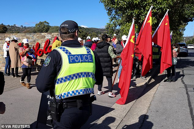 At one point, a fight broke out when a man fell to the ground and knocked over a raised speaker while a heavy police presence watched the confrontation.