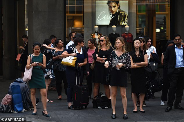 Dr Catherine Bennett said a rise in flu hospitalizations meant Australia could have a longer flu season this winter (pictured office workers in Sydney)