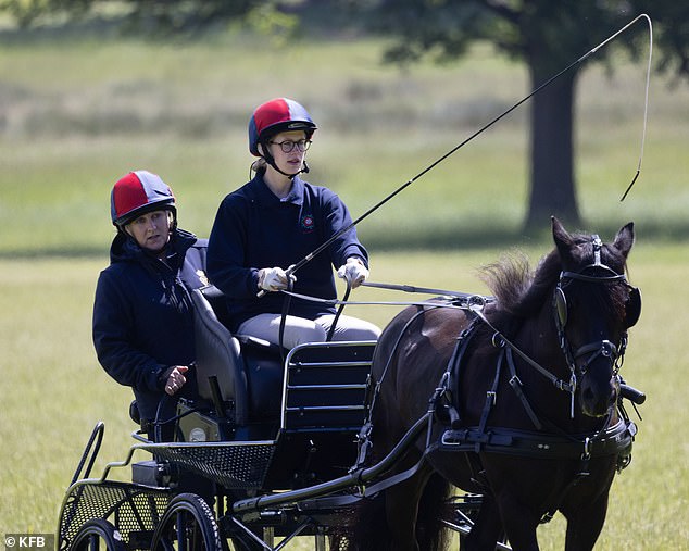 Dressed casually in a blue jumper, Lady Louise donned a red and blue striped riding helmet for the event along with white gloves as is customary when driving carriages.