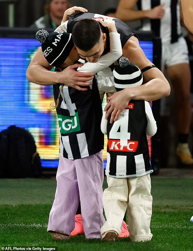 Maynard takes time to hug his family before his 200th game at Marvel Stadium