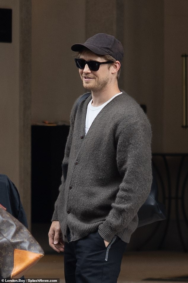 The actor protected his face with a baseball cap and sunglasses when he arrived at his hotel and chatted with a group of people outside.