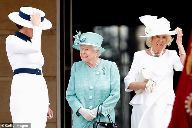 Melania Trump (left) and Camilla, Duchess of Cornwall, hold their hats during the welcome ceremony in the garden of Buckingham Palace for President Trump in 2019.