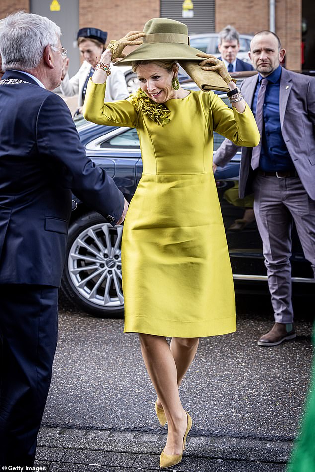 Queen Máxima of the Netherlands clings to her hat due to strong winds as she arrives at the Language at Sea Foundation's 10th anniversary celebration in April.