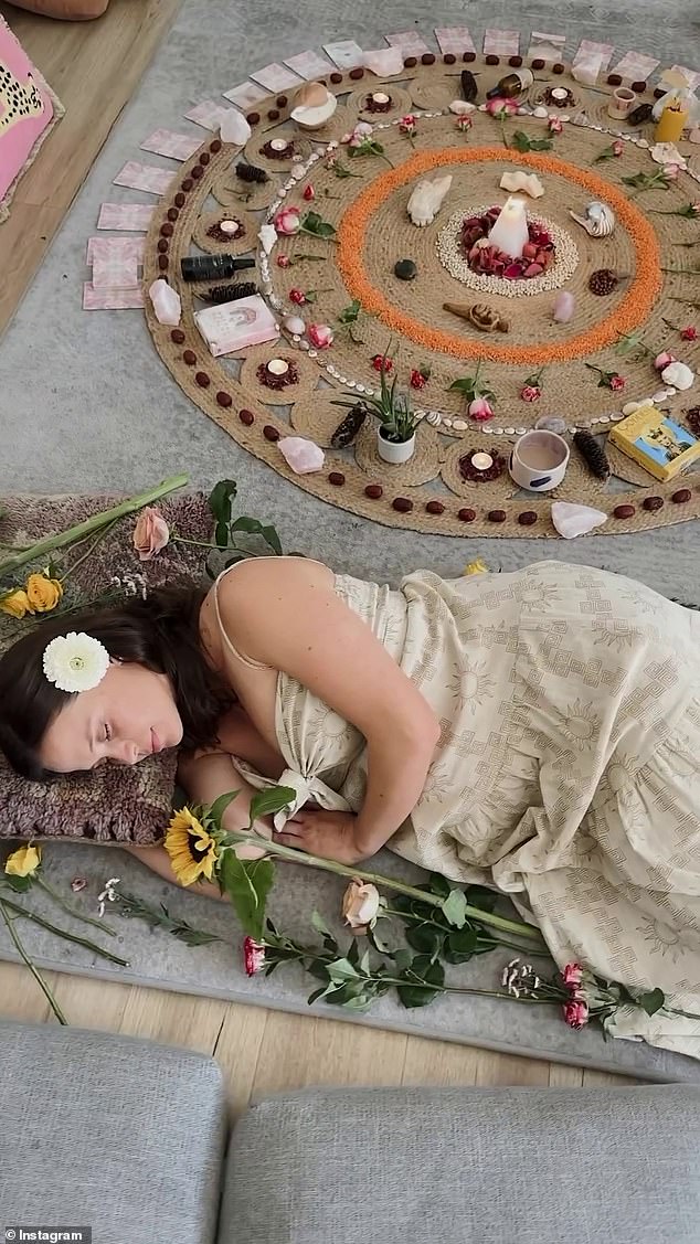 A ritual circle was set up in the center of the room with candles and crystals, and a pregnant Lauren was surrounded by flowers placed delicately around her.