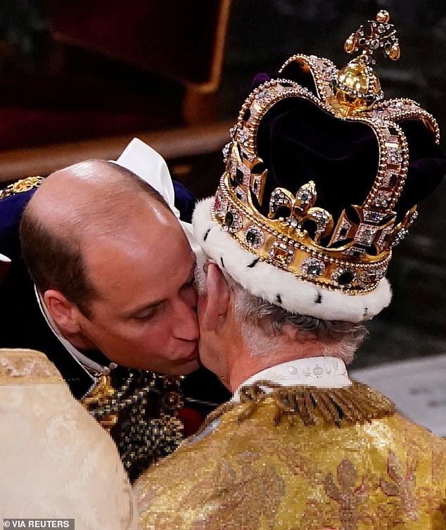 Prince William kisses his father, King Charles, on the cheek during the monarch's coronation ceremony in 2023