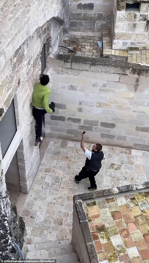 The free runner then hopped with one foot to a narrow outcropping on the side of a wall to propel himself to the next building, but the masonry collapsed beneath him.