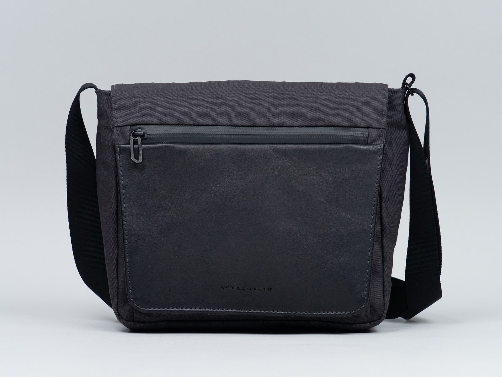 Black bag with front flap and long handle