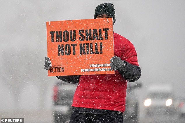 An activist opposing the death penalty protests during a snowstorm outside the United States Penitentiary in Terre Haute, Indiana, USA, January 15, 2020.