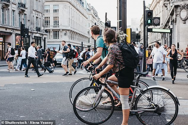 It is currently not a legal requirement to wear a helmet while cycling in the UK. In the photo, cyclists waiting for the traffic to change in London.