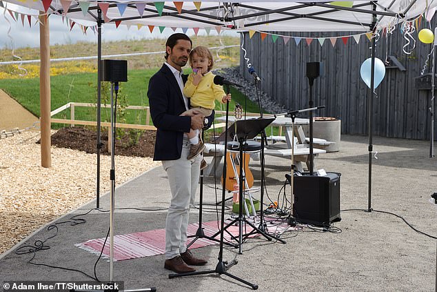 Prince Julian takes the microphone as he and his father, Prince Carl Philip, explore Prince Julian's playground at Naturum Getterön in Varberg.