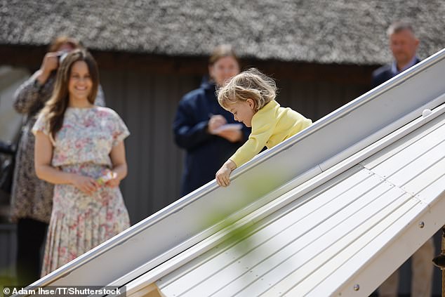 Princess Sofia smiled at her son as he tried out the slide at Prince Julian's playground.