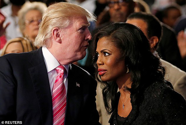 Then, Republican candidate Donald Trump (left) whispers to Omarosa (right), a three-time alum of his reality show The Apprentice, as they appear together at a campaign event in Detroit, Michigan, in September 2016.