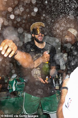 Derrick White couldn't wait to start spraying the champagne.