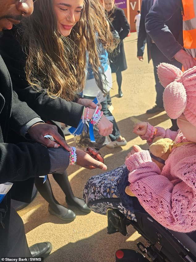 Other Taylor Swift fans show Florence their friendship bracelets at the concert