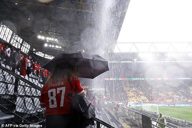 Fans sought shelter as bad weather worsened inside Signal Iduna Park.